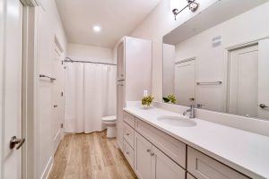 Updated modern bathrooms with granite countertops and wood floors